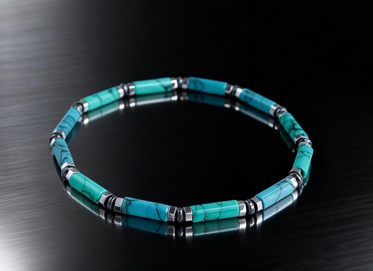 Turquoise tube bracelet with silver spacers on dark reflective surface