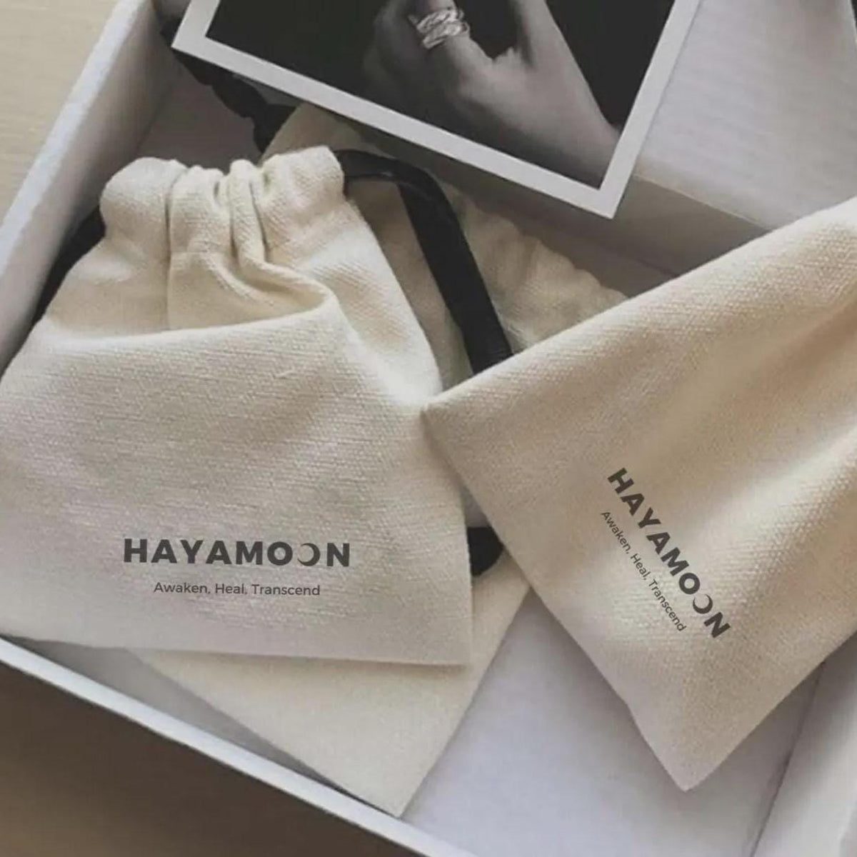 Hayamoon white gift box with two branded drawstring pouches and a photo card