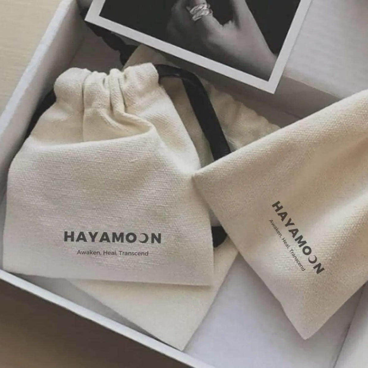 Hayamoon white gift box with two branded drawstring pouches and a photo card